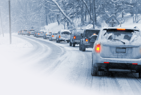 A line of cars on a snowy road