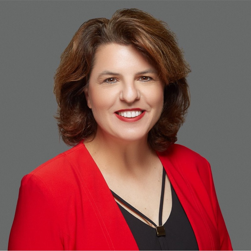 Wendy Mertz in A Red suit jacket and black blouse