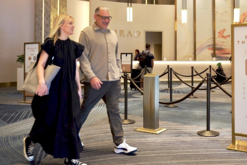 man and woman walking through a hotel lobby