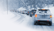 A line of cars on a snowy road